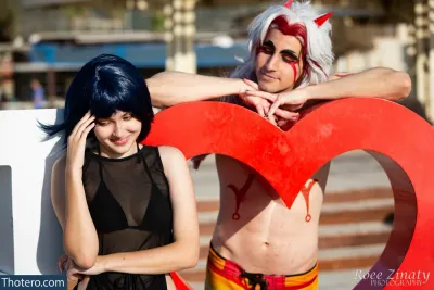 Emily_Cos - they are posing with a heart shaped sign in front of them