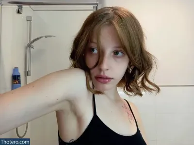 Agnese Innocente - woman in a black tank top taking a selfie in a bathroom