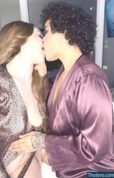 Rahaf Mohammed - a close up of a woman kissing a man in a robe