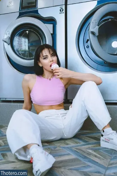 Sslavianka - sitting on the floor in front of a washing machine eating a donut