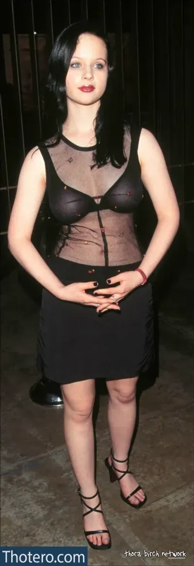 Thora Birch - a close up of a woman in a sheer top and black skirt