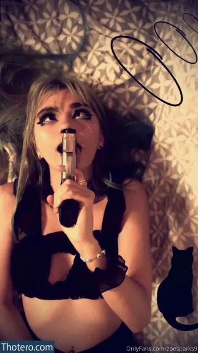 Zoesparks9 - woman in black lingerie holding a gun in her hand