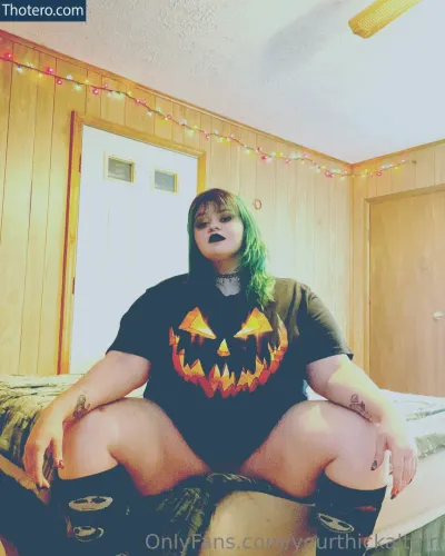 eurekalynnxx - woman with green hair sitting on a bed with a halloween pumpkin shirt