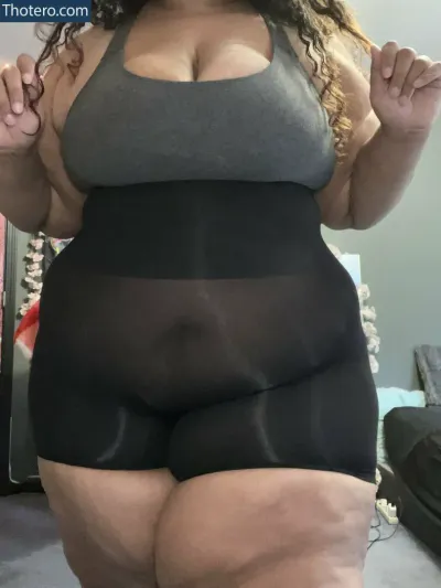 Thiccflix - a woman in a black and grey top and black shorts