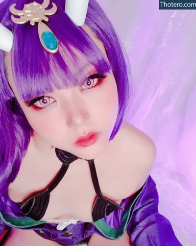 Aichanbot - purple haired girl with horns and a blue dress posing for a picture