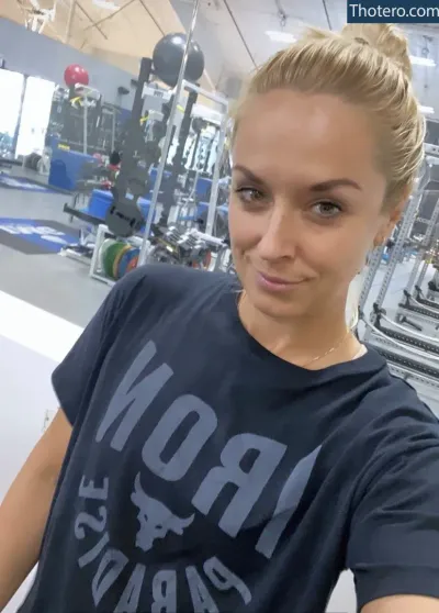 Sabine Lisicki - woman in a gym with a black shirt and a dumbble