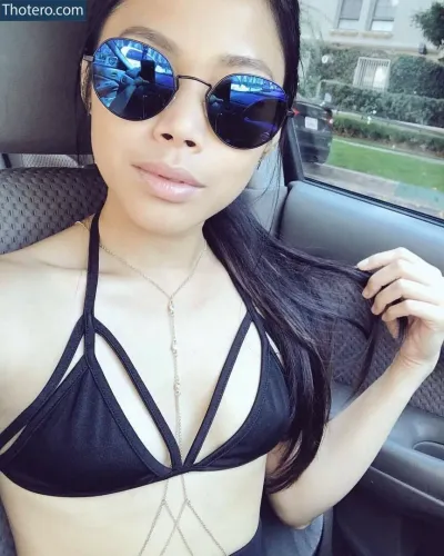 MissesMae - a close up of a woman in a bikini top and sunglasses