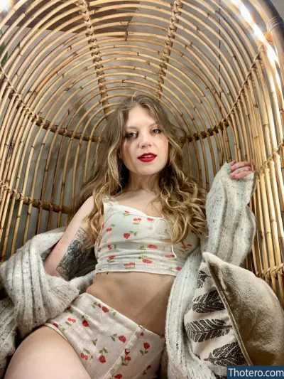 MissMousieMouse - woman sitting in a wicker chair with a blanket
