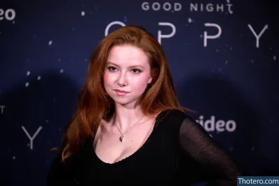 Francesca Capaldi - a close up of a woman in a black dress posing for a picture