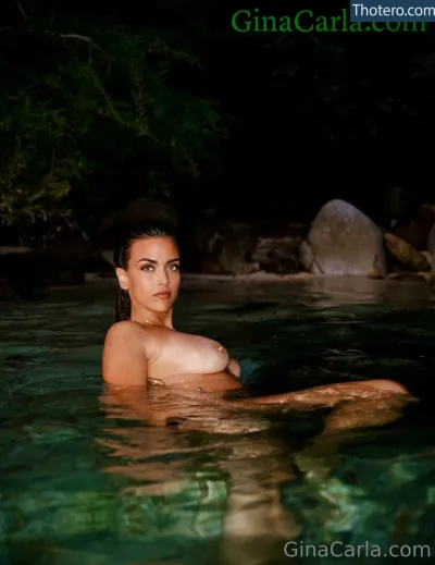 Gina Carla - woman in a pool with a large breast