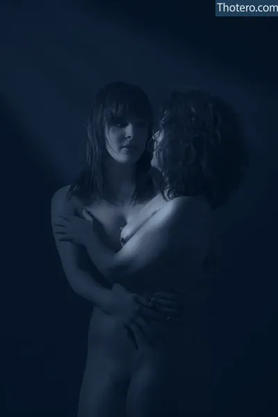 michellesoleil - woman hugging another woman in a dark room