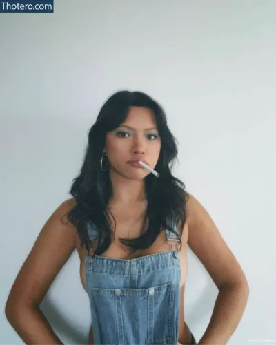 Julia Kelly - woman in overalls smoking a cigarette in her mouth