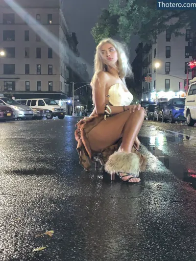 Merk Twain - sitting on a wet street in a bikini and furry boots