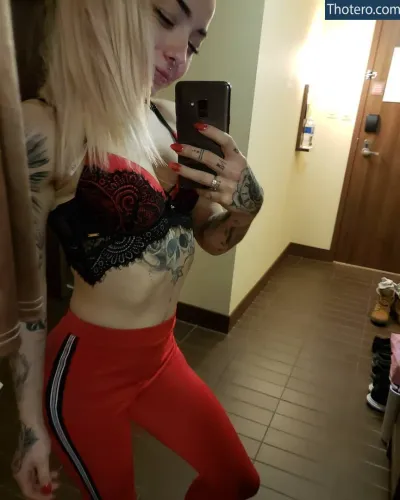 lunaxtreme - woman in red pants taking a selfie in a bathroom