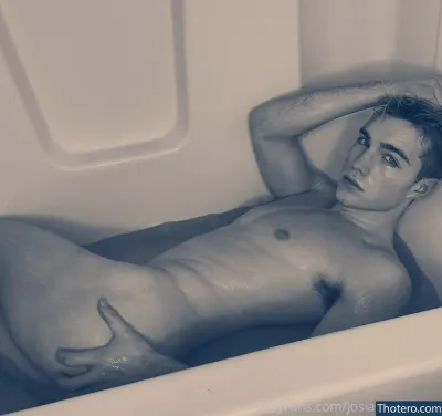 hazel_hoffman - man laying in a bathtub with his hands on his head