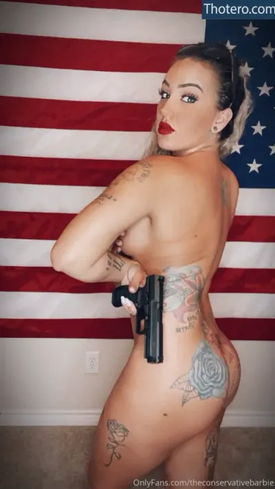 theconservativebarbie - a woman with a gun and a flag behind her