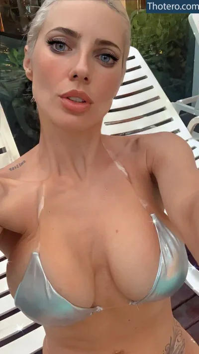 Tamara Bella - a close up of a woman in a bikini posing for a picture