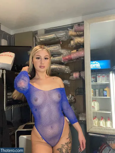 Barista Barbie - woman in a blue bodysuit posing in a store