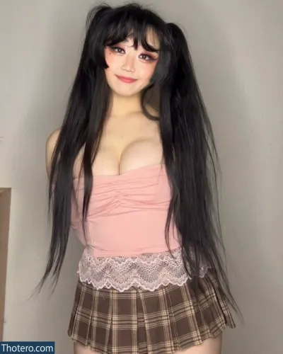 Mooncakeva - a close up of a woman with long black hair wearing a skirt