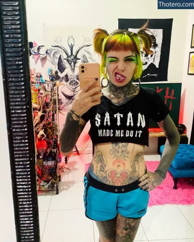 Mari Zombie - tattooed woman taking a selfie in a mirror with a cell phone