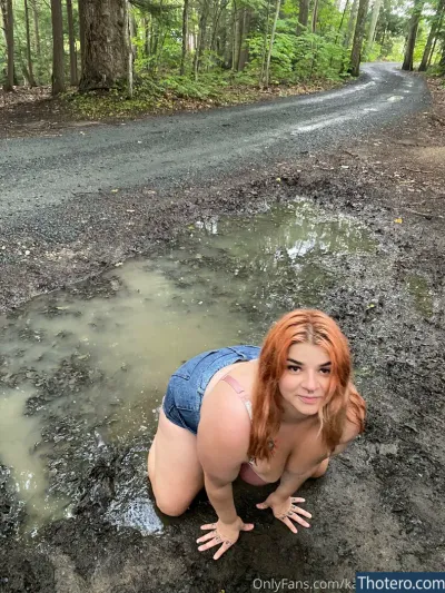 kallielonewolf17 - woman in a short jean shorts crouches in a puddle of mud