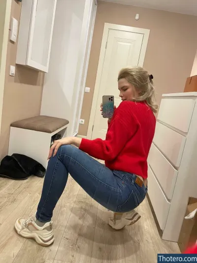 katesm - woman sitting on a stool in a kitchen taking a selfie