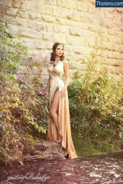 Jsa Stein - a woman in a long dress standing in a pond of water