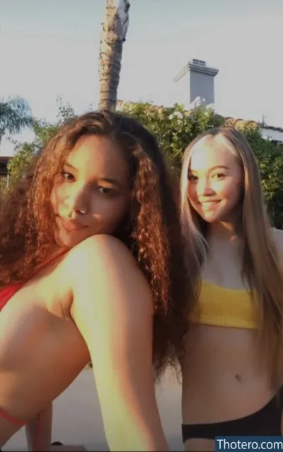 ASMR Lia - two women in bikinis posing for a picture in front of a palm tree