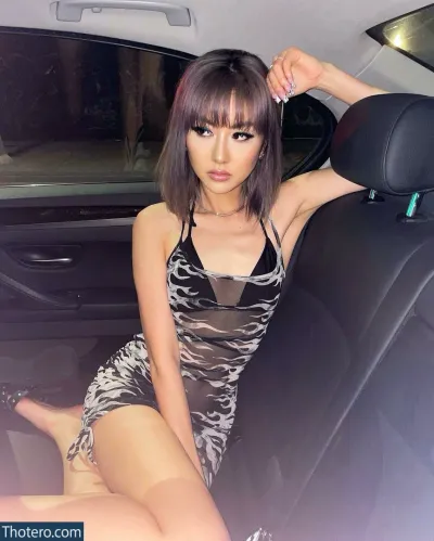 DJ Camgirl - woman sitting in a car with her legs crossed