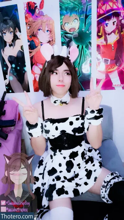 Mei_Succubus - a woman in a cow print dress holding up a picture of a cow print