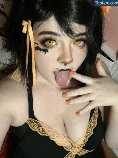 The.bunny.bee - woman with black hair and orange nails sticking out her tongue