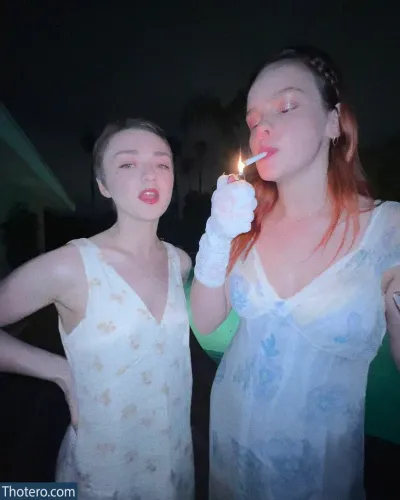 Maisie Williams - they are two women standing next to each other blowing out a candle