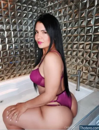 Yomi Ochoa - woman in a purple bikini sitting in a bathtub