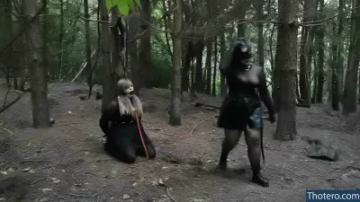 rosejadestorm - there is a woman in a black outfit and a man in a black outfit in the woods