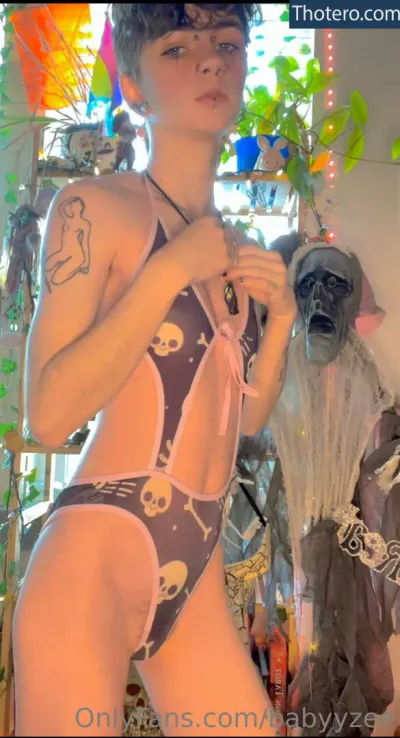 Babyyzee - woman in a bikini and mask standing in a room