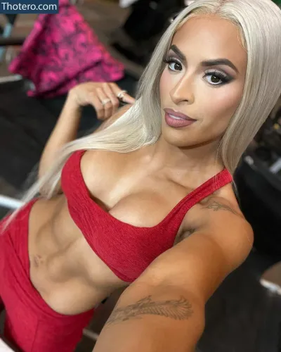 Zelina Vega - a close up of a woman with a very big breast posing for a picture