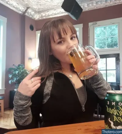 Pornstar Gauge - woman drinking a beer from a glass in a restaurant