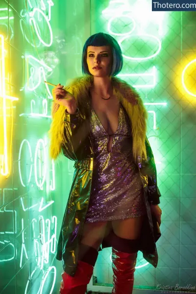 Miroslava Ladovir - in a neon dress and boots smoking a cigarette