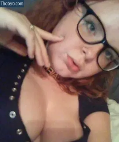 Corellianmaiden - woman with glasses and a black top laying on a bed