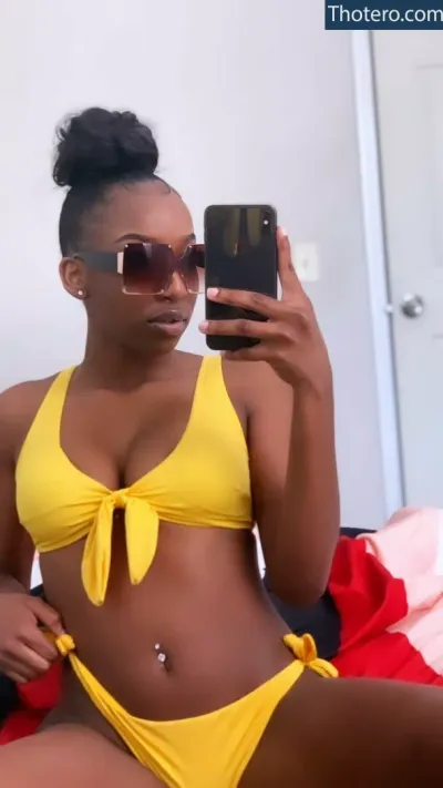 throatog - woman in yellow bikini top taking selfie with cell phone