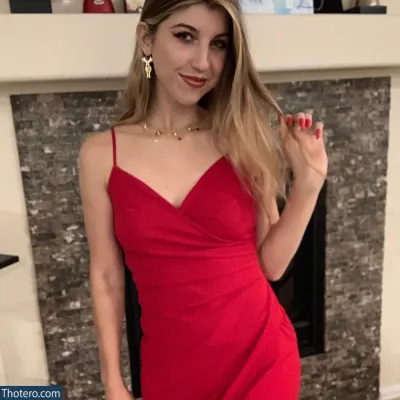 FrivolousFox ASMR - a close up of a woman in a red dress posing for a picture