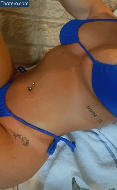 Holly S Gloucester - woman in a blue bikini laying on a bed