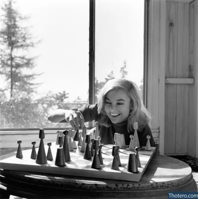 Linne Nanette Ahlstrand - woman playing chess with a large set of bells on a table