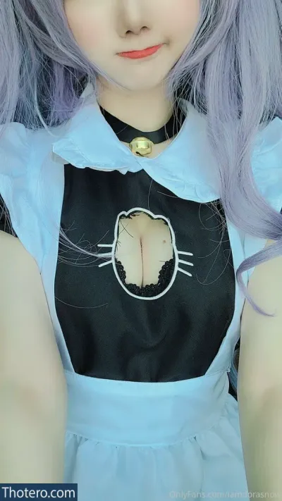 Iamdorasnow - a close up of a doll with purple hair and a black shirt