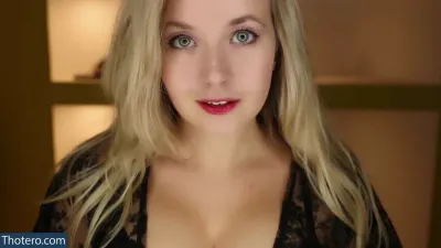 ValeriyaASMR - a close up of a woman with long blonde hair and a black top