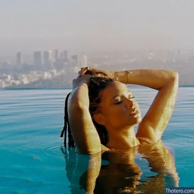Rhyon Nicole Brown - woman in a bikini in a pool with a city in the background