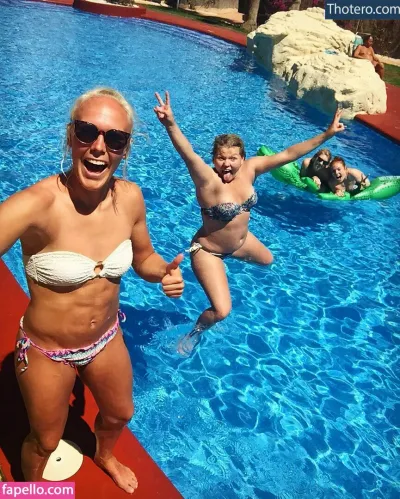 Maria Thorisdottir - woman in bikinis and sunglasses standing in a pool with two children