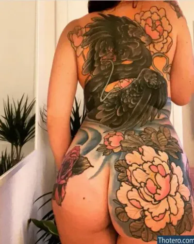 Peachypeony - a close up of a woman with a tattoo on her back