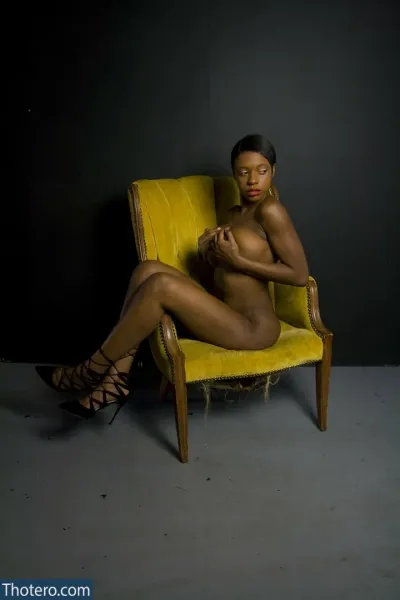 Kelia Gipson - woman sitting in a chair with a yellow chair