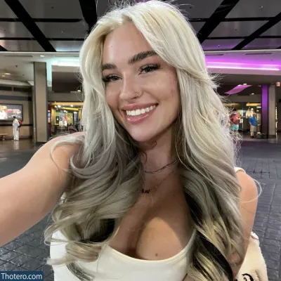 Viperous - blonde woman with long hair taking a selfie in a mall